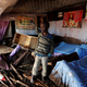 A child walks in his house, which was partly destroyed by flooding water after a dam burst, in Solio town near Nakuru, Kenya May 10, 2018.